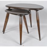 A nest of two Ercol dark-stained pebble-shaped tables, each on splayed legs - 49 cm. wide max.
