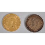 A half sovereign coin dated 1911 together with a silver sixpence coin dated 1935.