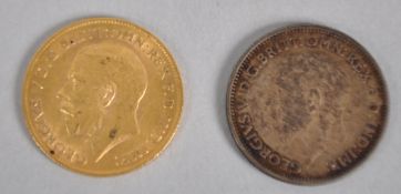 A half sovereign coin dated 1911 together with a silver sixpence coin dated 1935.