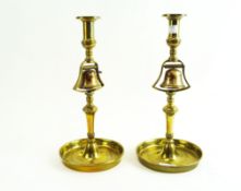 A pair of brass tavern candlesticks, of usual turned baluster form,