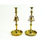 A pair of brass tavern candlesticks, of usual turned baluster form,