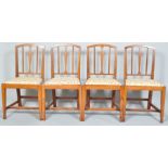 A set of six early 19th century elm dining chairs with slender vase shaped splat and reeded