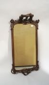 A Rococo style wall hanging mirror with carved decoration and acanthus leaves and flowers