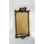 A Rococo style wall hanging mirror with carved decoration and acanthus leaves and flowers