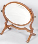 An Edwardian mahogany dressing table mirror, of oval form, inlaid in ebony and satinwood stringing,