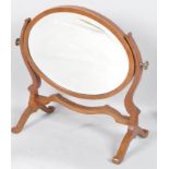 An Edwardian mahogany dressing table mirror, of oval form, inlaid in ebony and satinwood stringing,