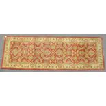 A Ziegler wool runner, woven with interlocking ocre and yellow foliage,