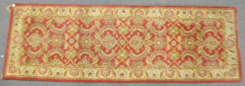 A Ziegler wool runner, woven with interlocking ocre and yellow foliage,