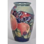A small Moorcroft pomegranate and finches pattern vase, decorated with a bird,