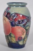 A small Moorcroft pomegranate and finches pattern vase, decorated with a bird,