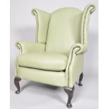 A 20th century wingback armchair,