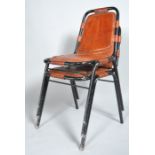 A pair of tubular chairs with black painted frames, and tan leather seats and backs, 20th century,