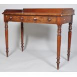A Victorian 19th century mahogany wash stand with two drawers and raised on turned tapering legs,