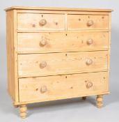 A Victorian pine chest of two short and three long drawers, on replacement bun feet,