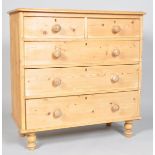 A Victorian pine chest of two short and three long drawers, on replacement bun feet,