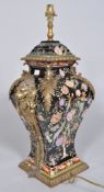 A Chinese porcelain famille noir style brass mounted lampbase,