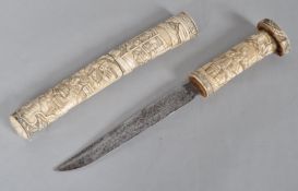 An Oriental Tauto the bone scabbard and grip carved with a cascade of figures,