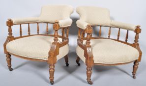 A pair of Victorian tub armchairs, each upholstered in cream cotton with black dots,