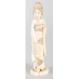 A Japanese ivory Okimono of a lady, modelled in traditional costume, on oval base, 15cm high