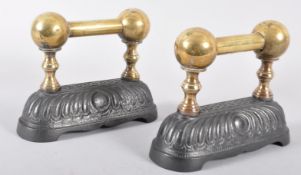 A pair of Victorian cast iron and brass fire dogs, with twin brass ball finials,