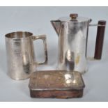 A Trench Art silver plated covered jug with bakelite finial and handle formed from a 12 pounder