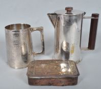 A Trench Art silver plated covered jug with bakelite finial and handle formed from a 12 pounder