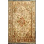 A cream and grey ground large carpet, the centre with red ground quatrefoil medallion,