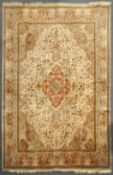 A cream and grey ground large carpet, the centre with red ground quatrefoil medallion,