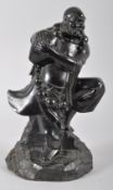 A Chinese carved black stone figure of an Immortal,