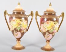 A pair of Continental porcelain oviform two handled vases and covers, circa 1900,