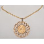 A large yellow metal abstract sun design pendant, set with a full sovereign coin dated 1965.