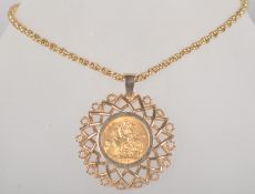 A large yellow metal abstract sun design pendant, set with a full sovereign coin dated 1965.
