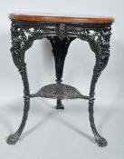 A cast iron pub table, the circular oak top above moulded frieze, cast with figures of Britannia,