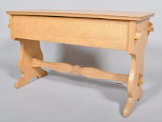 A late Arts & Crafts pegged oak blanket box, the rectangular top with shaped corners,