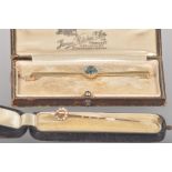 A 15ct gold (stamped) bar brooch set with an oval faceted cut aquamarine