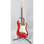 A Gear 4 Music electric guitar, with red and white body,