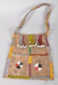 A beaded leather Native American bag, decorated with colourful geometric beaded ornament,
