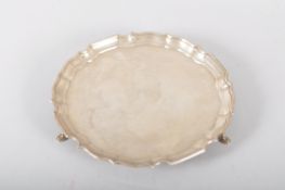 A silver salver, of plain form with Chipppendale border, raised on three pad feet, Sheffield 1966,