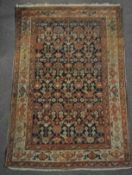 A Middle Eastern carpet with central blue ground,