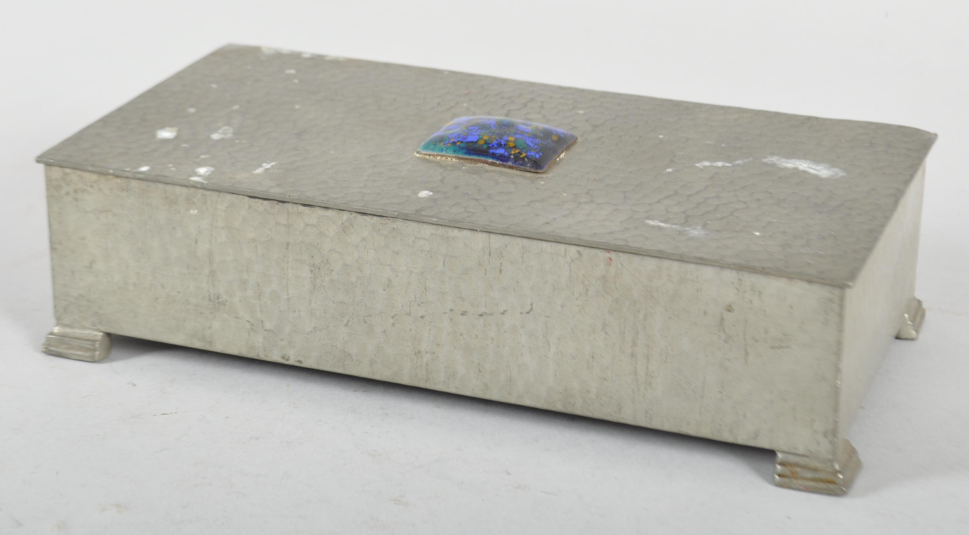 An Arts and Crafts hammered pewter rectangular tobacco box and cover,