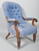 A Victorian mahogany balloon button-back armchair, upholstered in blue floral damask,