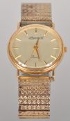 A yellow gold cased Ingersoll quartz watch. Circular champagne dial with baton markings.