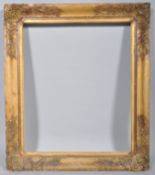 A carved giltwood and gesso picture frame, 19th century, with rocaille border,