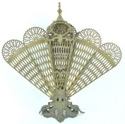 A cast brass peacock fire screen having a nine section fan each with pierced peacock feather