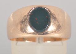 A yellow metal oval bloodstone set signet ring. No hallmark - tests indicate 9ct gold.