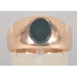 A yellow metal oval bloodstone set signet ring. No hallmark - tests indicate 9ct gold.