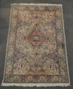 A Middle Eastern carpet the central cream ground with central medallion and floral decoration with