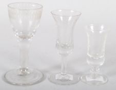 An 18th century wine glass with engraved bowl and two small bell-shaped sherry glasses (3)