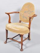An 18th century style mahogany armchair, with scrolled arms and uprights,