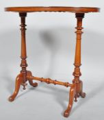 A mahogany oval side table, the waved frame above turned baluster twin supports,